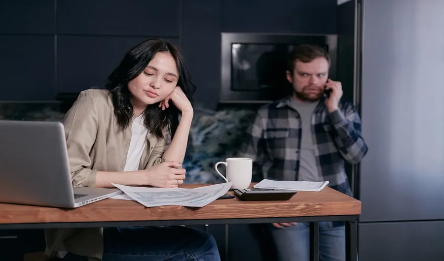 a concern couple looking at bills and considering post-settlement funding